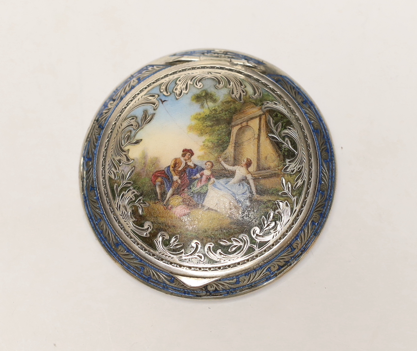 An early 20th century Austrian 935 sterling and enamelled circular compact, with fete gallant scene, 83mm, (a.f.).